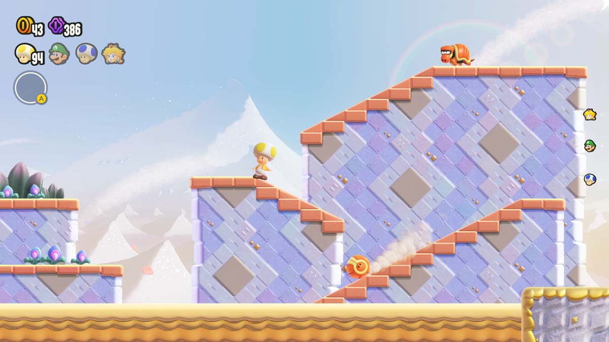 スーパー マリオ ブラザーズのゲーム レベルで、黄色い帽子をかぶったキャラクターが雪の斜面を滑り降ります。