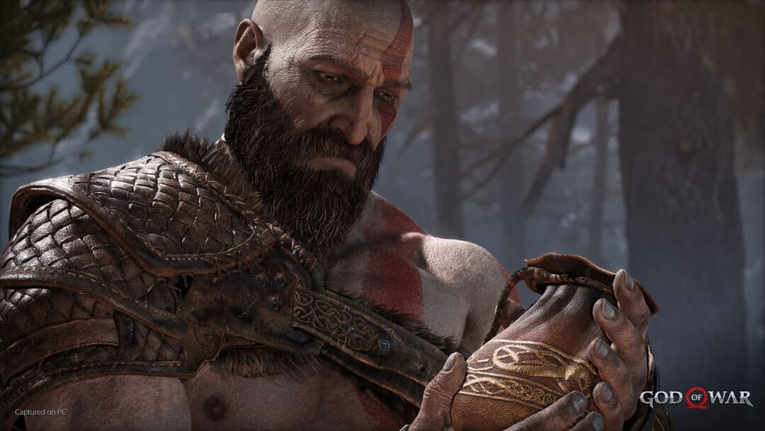 革のバッグを持っているクラトスを示すゲームの神の戦争のスクリーンショット