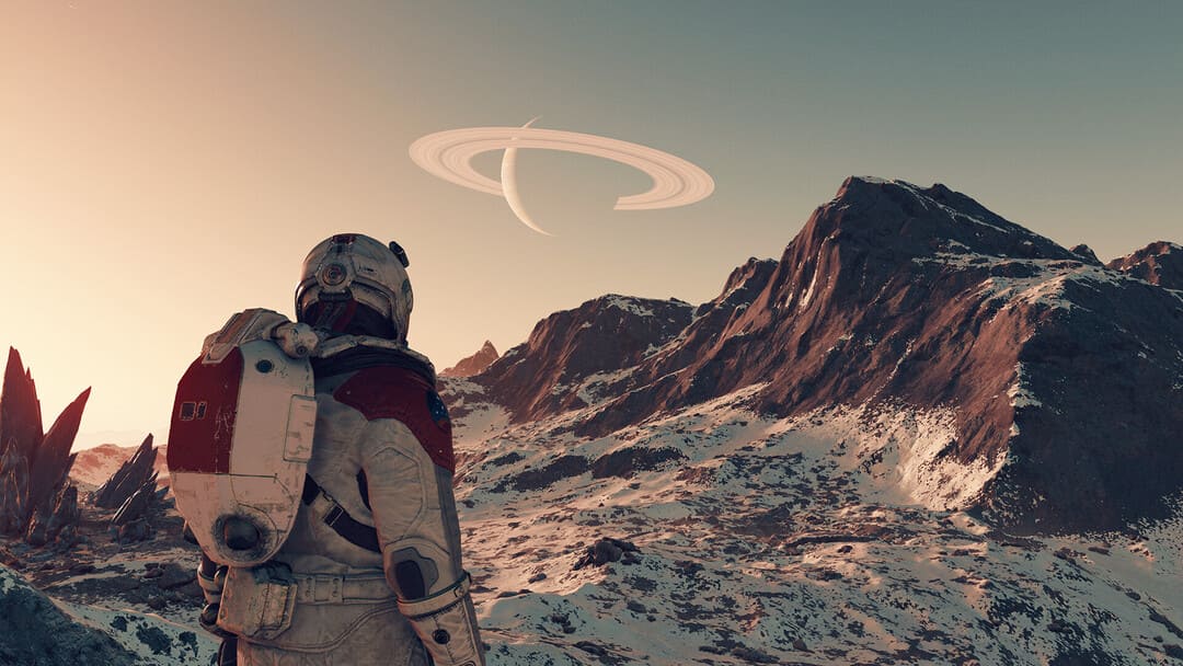 ゲームのスターフィールドのスクリーンショットは、空に土星のような鳴り響く惑星を備えた岩だらけの雪に覆われた山を見て宇宙服を着ている人を見せています